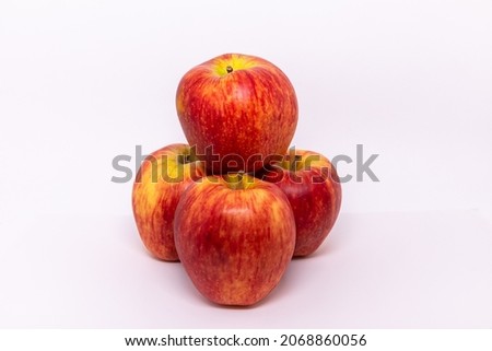A bunch of red apples on a white background