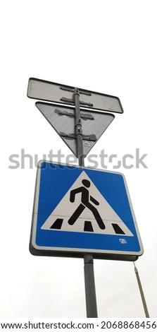 Moscow, Russia - April 26, 2020: Traffic lights on the street. The light is green. Pedestrians are allowed to cross the road. Pedestrian crossing sign. Vertical picture.
