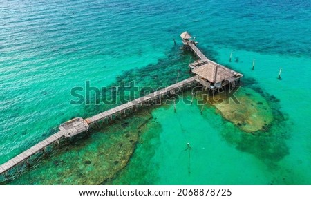 Wooden beach bar in sea and hut on pier in koh Mak island, Trat, Thailand Royalty-Free Stock Photo #2068878725