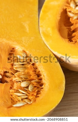orange pumpkin with seeds cut in half close-up