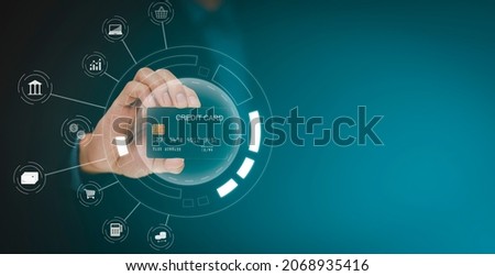 Businessman holding credit card for makes a purchase on the Internet on the laptop computer with credit card, online payment, shopping online, e-commerce, internet banking, spending money concept.