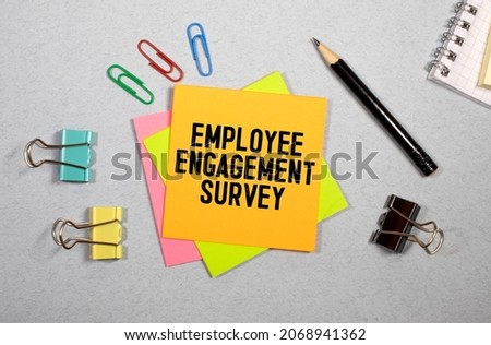 Employee Engagement Survey sign written on sticky note pinned on wooden wall Royalty-Free Stock Photo #2068941362