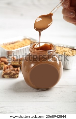 Chocolate jar with spoon on white background