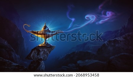 Golden magic lamp on bright and blue background Royalty-Free Stock Photo #2068953458
