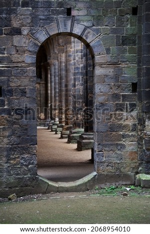 Doorway leading to gothic cloisters dark moody scene