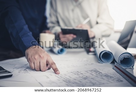 Architect working on blueprint. Architects workplace - architectural project, blueprints, ruler, calculator, laptop and divider compass. Construction concept. Blue print is fake only for stock photo. Royalty-Free Stock Photo #2068967252