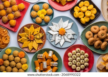 Group of Indian assorted sweets or mithai with diya Royalty-Free Stock Photo #2068990322