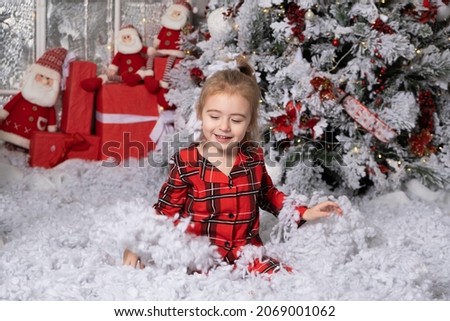 Cute little baby girl having fun in christmas decorated room. merry christmas concept.