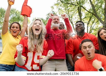 Football fans celebrating the win of their team at a tailgate party Royalty-Free Stock Photo #2069011736