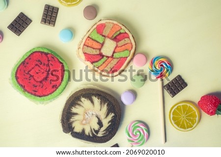 Colorful and various kind of sweets, candies and cake over white background