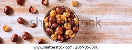 Chestnuts panorama, shot from the top on a rustic wooden background with a place for text Royalty-Free Stock Photo #2069056808