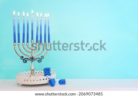 Religion image of jewish holiday Hanukkah background with menorah (traditional candelabra) and spinning top toy
