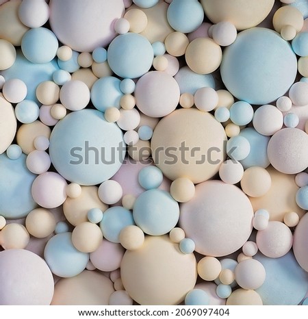 Abstract 3d background with pastel colors matte balls. delicate blue, pink, beige balls different sizes of spherical shape. texture background. Close-up. High quality photo