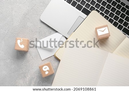 Cubes with digital technology icons, notebooks and laptop on grunge background