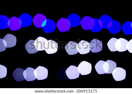Blue and white bokeh abstract on black background