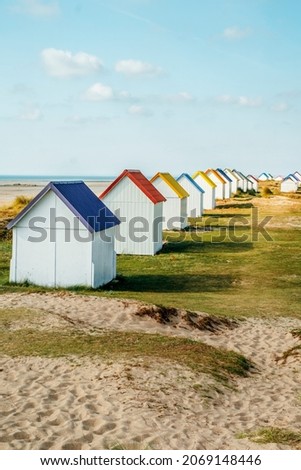 Row of colorful huts on the dune beach of Gouville-sur-Mer, Lower Normandy, France Royalty-Free Stock Photo #2069148446