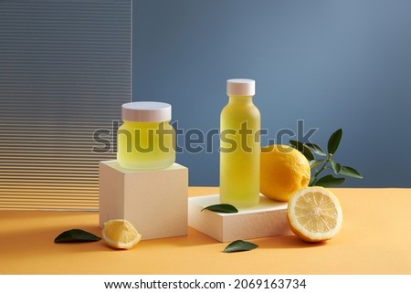 Lemon extract in a white square podium in a blue background with green leaf for food advertising , photography food advertising 
