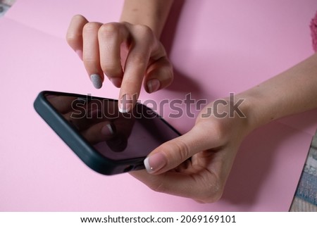 phone in female hands with a green screen for chroma key
