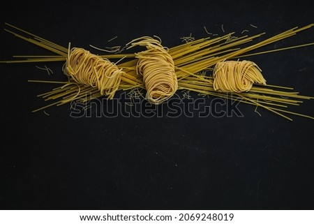 
different types of pasta on a black background