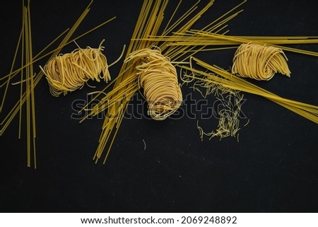 
different types of pasta on a black background