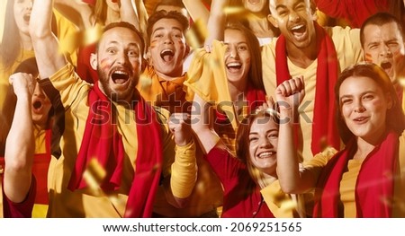 Spanish emotive football, soccer fans cheering their team with a red scarfs at stadium. Excited fans rejoice goal, supporting favourite players. Concept of sport, emotions, team event, competition. Royalty-Free Stock Photo #2069251565