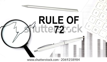 RULE OF 72 text on the document with pen,graph and magnifier,calculator Royalty-Free Stock Photo #2069258984