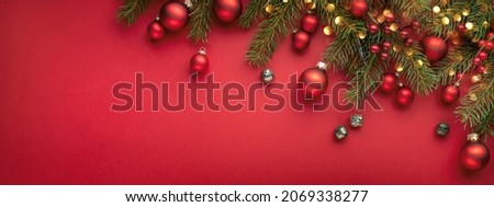 Red Christmas banner with fir branches, lights and decorations . Royalty-Free Stock Photo #2069338277