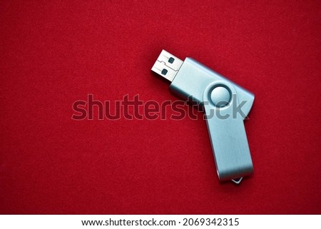 USB flash drive on a red velvet background