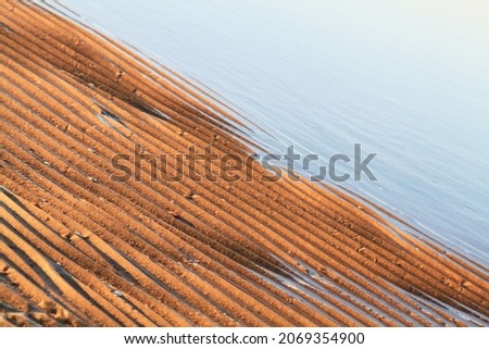 Sea water and golden sand closeup. Selective focus. High quality photo Royalty-Free Stock Photo #2069354900