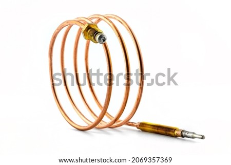 Macro photo of a temperature probe made of copper in the shape of a spiral with threaded tips, isolated on a white background.