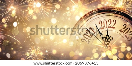 2022 New Year - Clock And Fireworks - Countdown To Midnight  - Golden Abstract Defocused Background Royalty-Free Stock Photo #2069376413