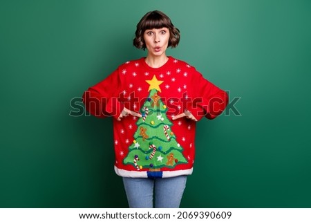 Photo of shocked funny young woman dressed red pullover pointing fingers herself isolated green color background
