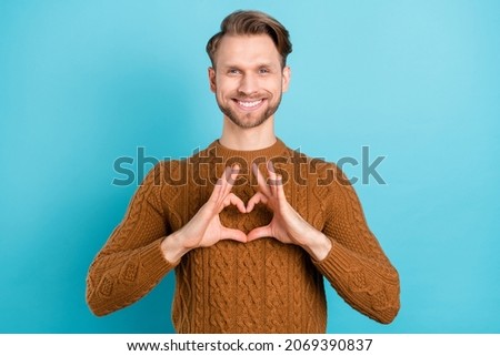 Photo of happy charming affectionate man make fingers heart shape smile isolated on blue color background