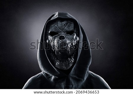 Monster in hooded cloak at night Royalty-Free Stock Photo #2069436653