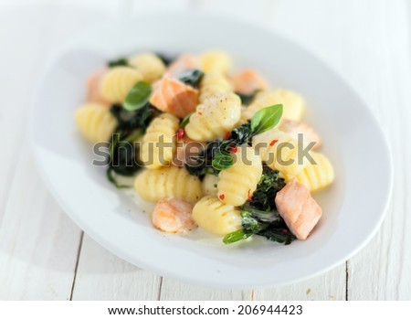 Italian gnocchi pasta, or dumplings, sauteed and served with diced salmon and basil