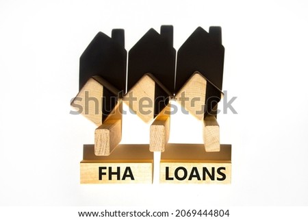 FHA federal housing administration loans symbol. Concept words 'FHA federal housing administration loans' on wooden blocks on a beautiful white background. Business and FHA loans concept. Copy space.