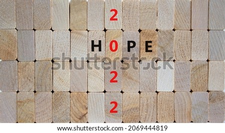 2022 hope new year symbol. Wooden blocks with words 'Hope 2022'. Beautiful wooden background, copy space. Business, 2022 hope new year concept.