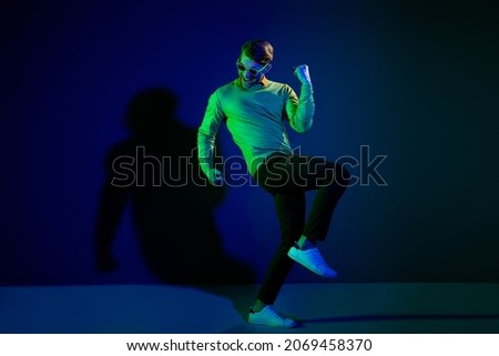 Full body photo of attractive young positive man good mood winner wear sunglass isolated on neon background
