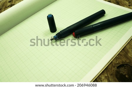 pen on green graph paper