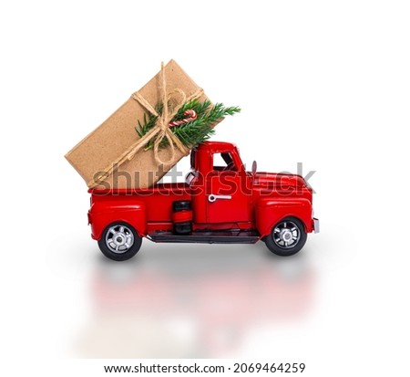 Isolated red car with a Christmas gift on a white background