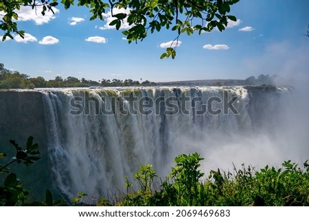 Victoria Falls with rising water smoke, green picture frame