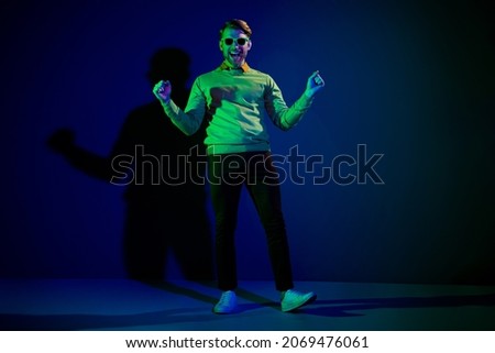 Full length body size photo guy wearing sunglass gesturing like winner isolated dark blue color background