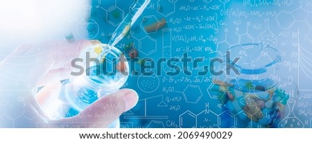 Hand of scientist holding flask with lab glassware and test tubes in chemical laboratory background,