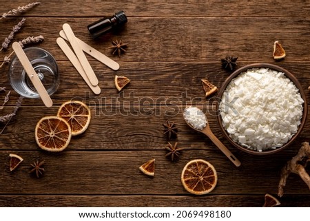 Set for crafting candle on wooden background. Eco soy wax on white table. DIY candle. Hobby concept