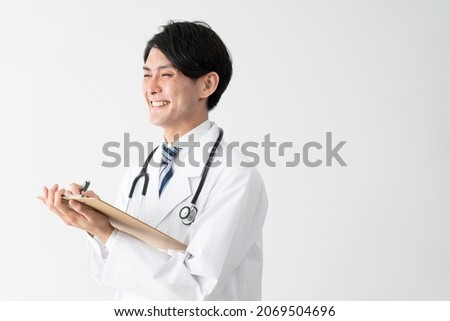 Working Asian young male doctor