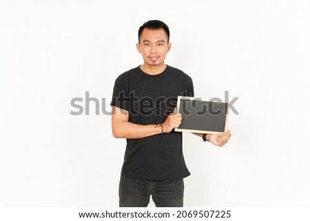 Showing, Presenting and holding Blank Blackboard of Asian Man Wearing Black T-Shirt Isolated On White Background
