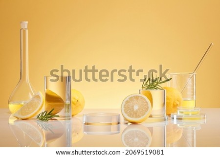 Background for  Biological experiment presentation lemon extract and rosemary leaves and yellow water in biological test tubes. Production of cosmetics based on Citrus
 Royalty-Free Stock Photo #2069519081