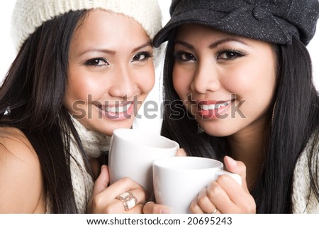Two beautiful asian women drinking coffee