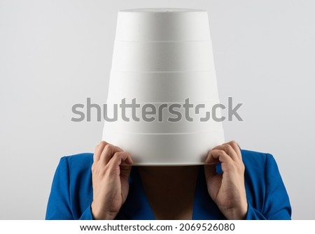 business woman hiding under a trash can. isolated on white background. woman Covering Face Royalty-Free Stock Photo #2069526080