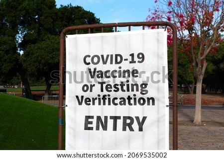 Covid-19 Vaccine or Testing Verification sign at the entrance to public event, concert or stadium